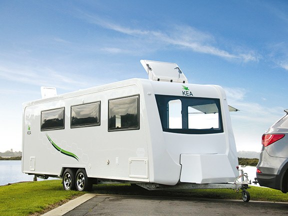 White touring caravan hitched to a car